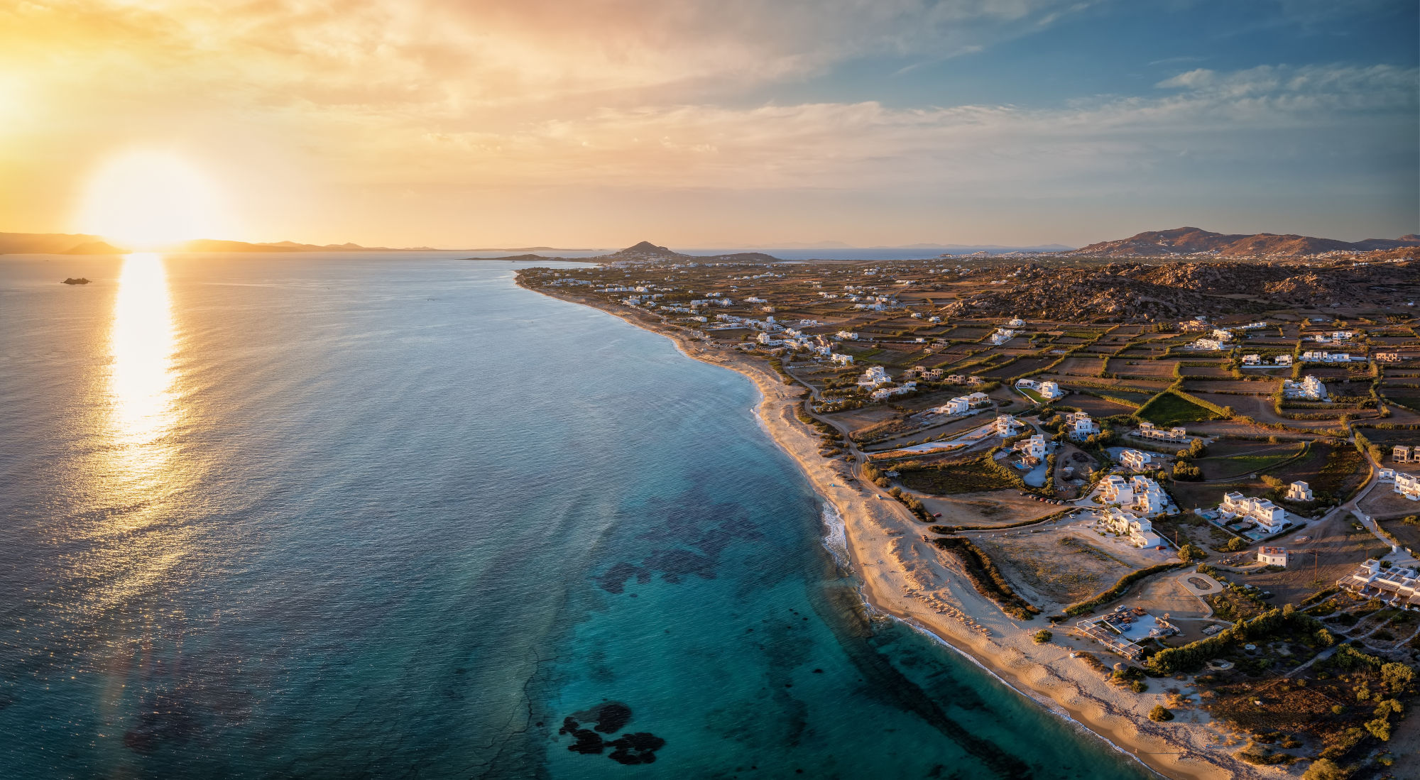 Aerial_view_of_endless_beaches_with_island_on_side