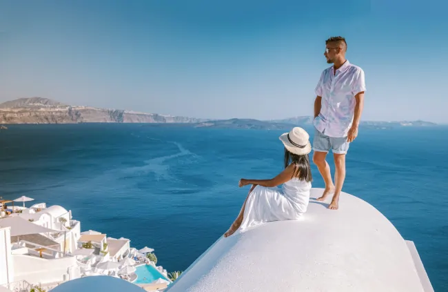 couple_sitting_on_a_church_with_view_of_sea